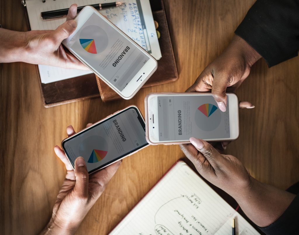 picture of 3 hands holding 3 phones with the words branding on phone sceen